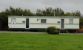 Close up view of static caravan located on camping site - used as common room, toilet and shower etc